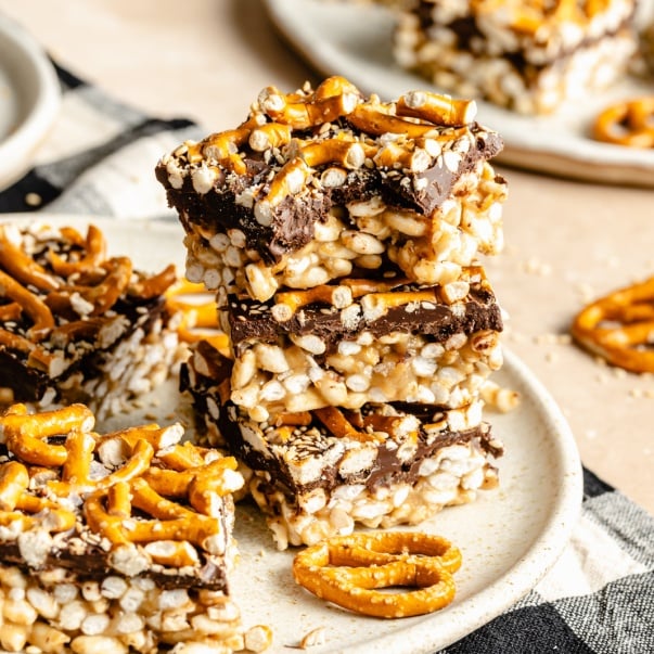 tahini rice krispie treats topped with pretzels in a stack