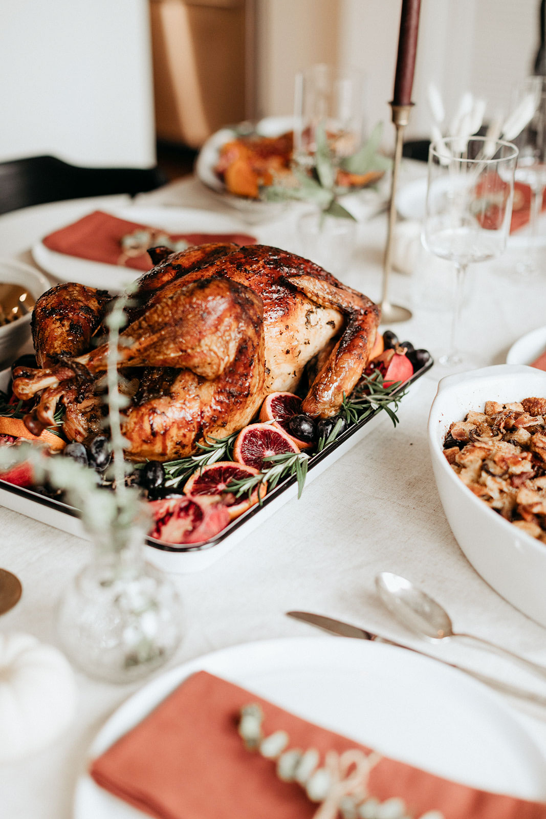 whole maple roasted turkey on a platter on a thanksgiving table