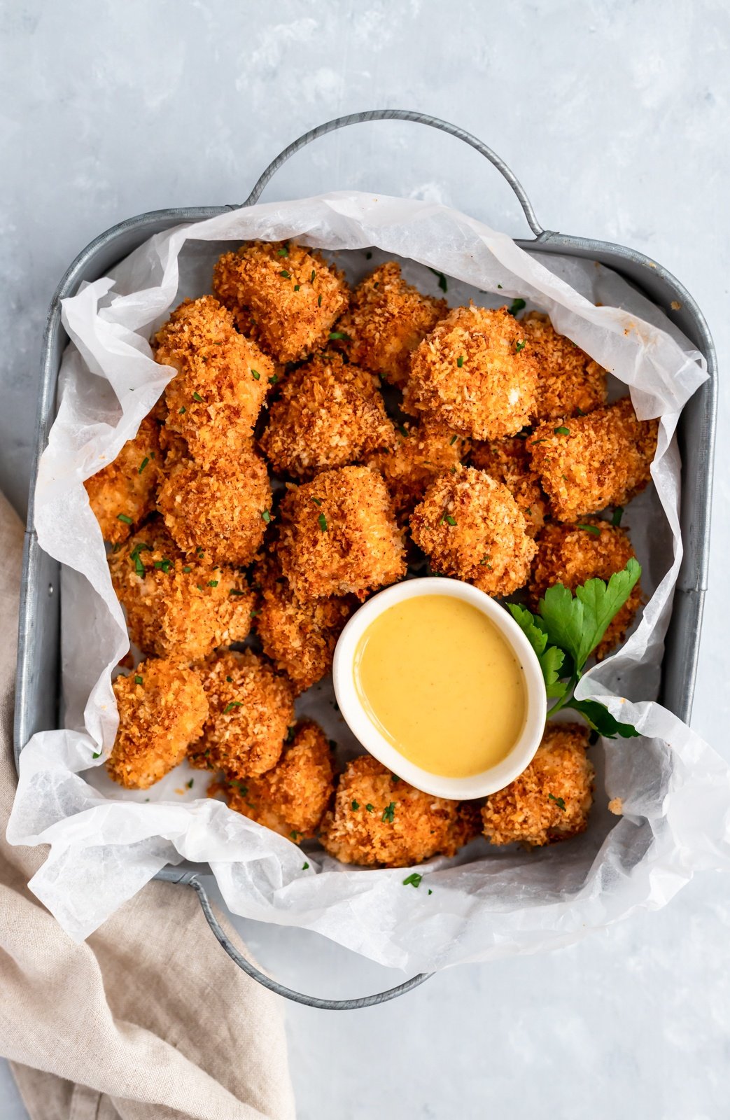 baked chicken nuggets in a serving plate with honey mustard