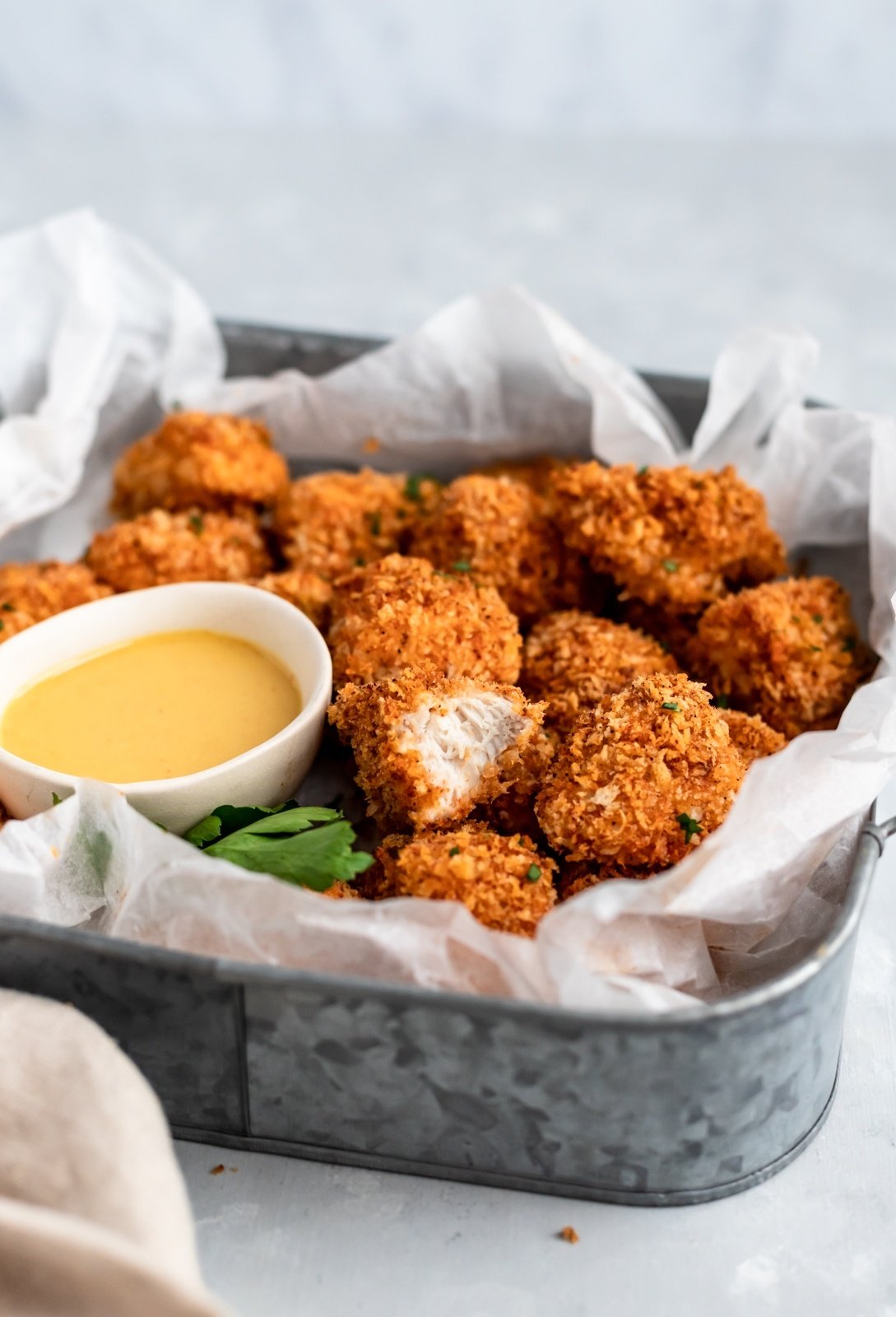 crispy baked chicken nuggets in a basket with honey mustard