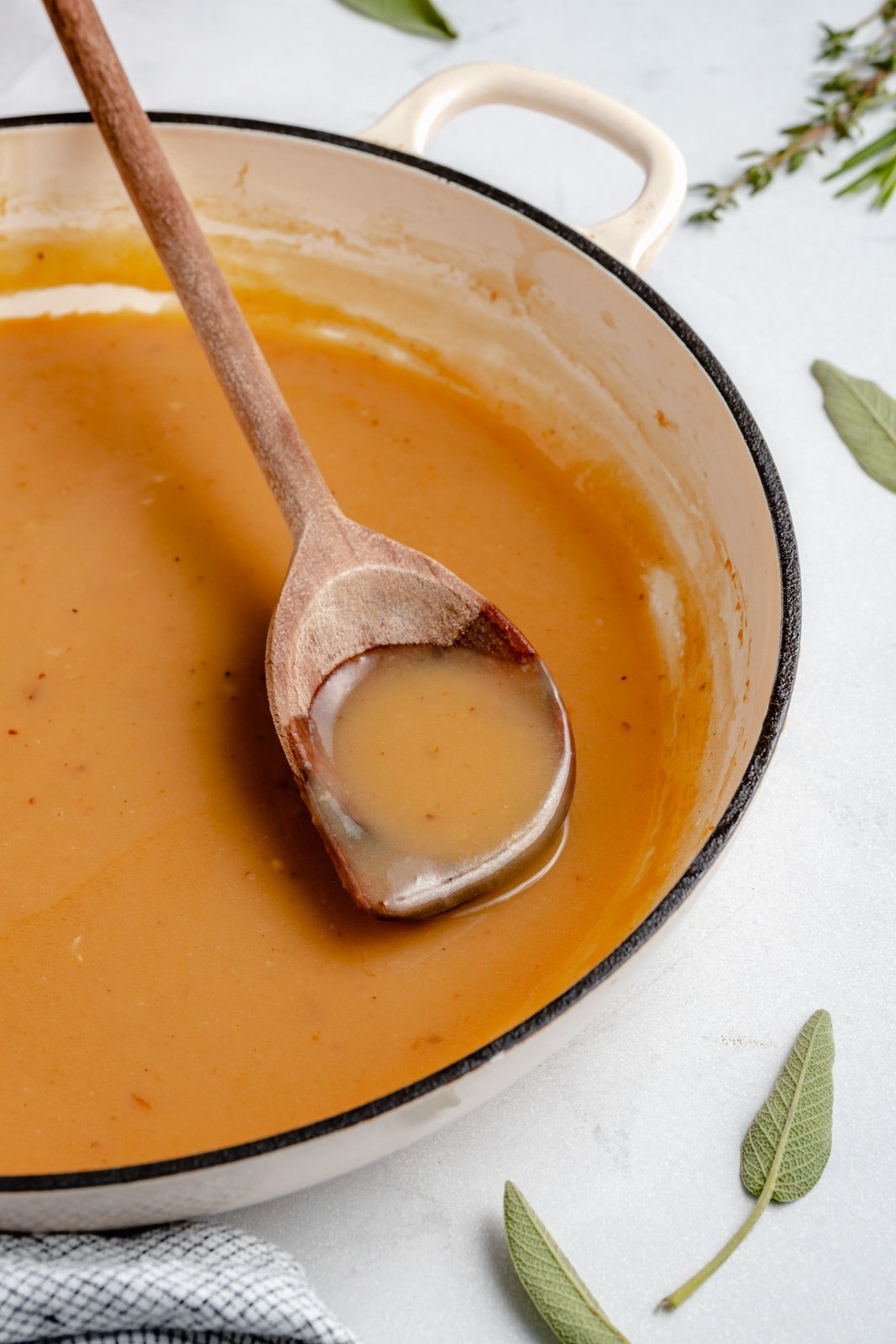 stirring a turkey gravy recipe in a skillet