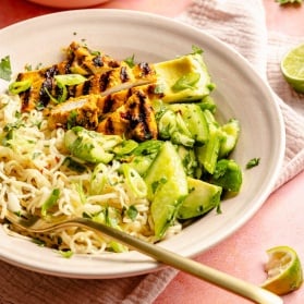 grilled turmeric chicken bowl with a fork