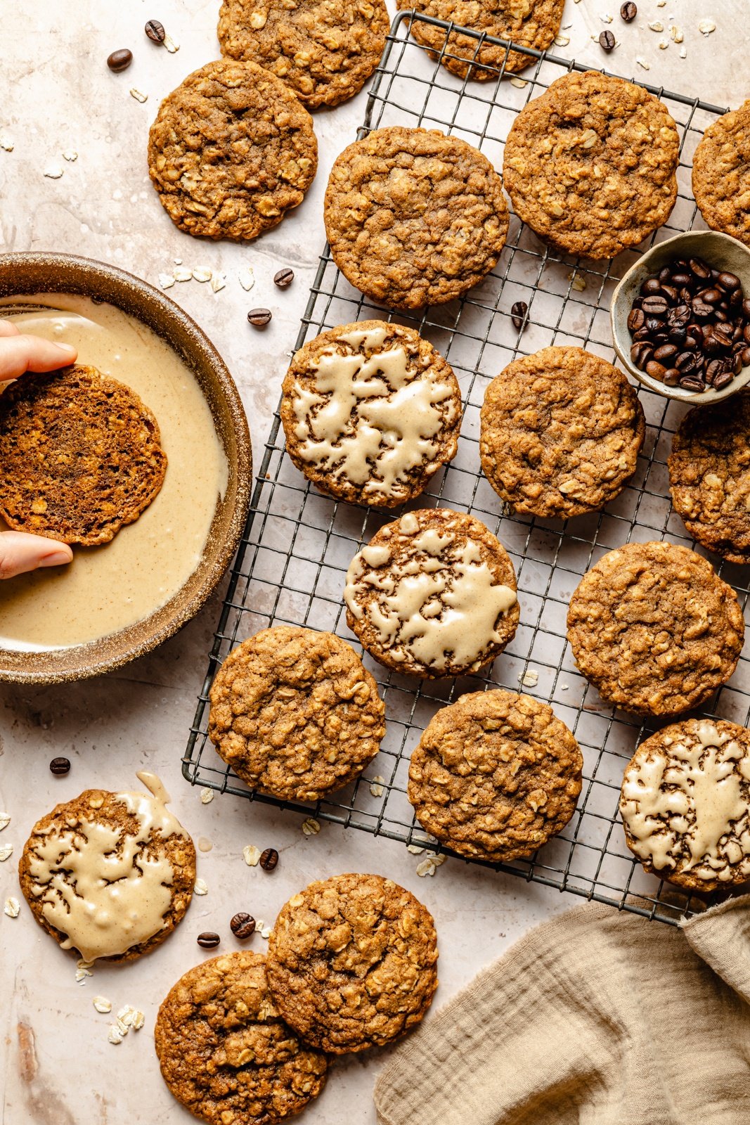 dipping chewy oatmeal latte cookies into espresso icing