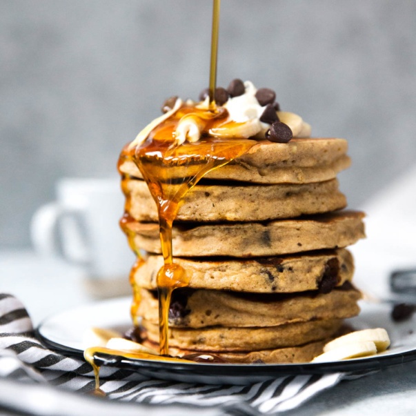 banana bread pancakes being drizzled with syrup