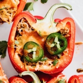 quinoa stuffed bell peppers topped with jalapeño slices