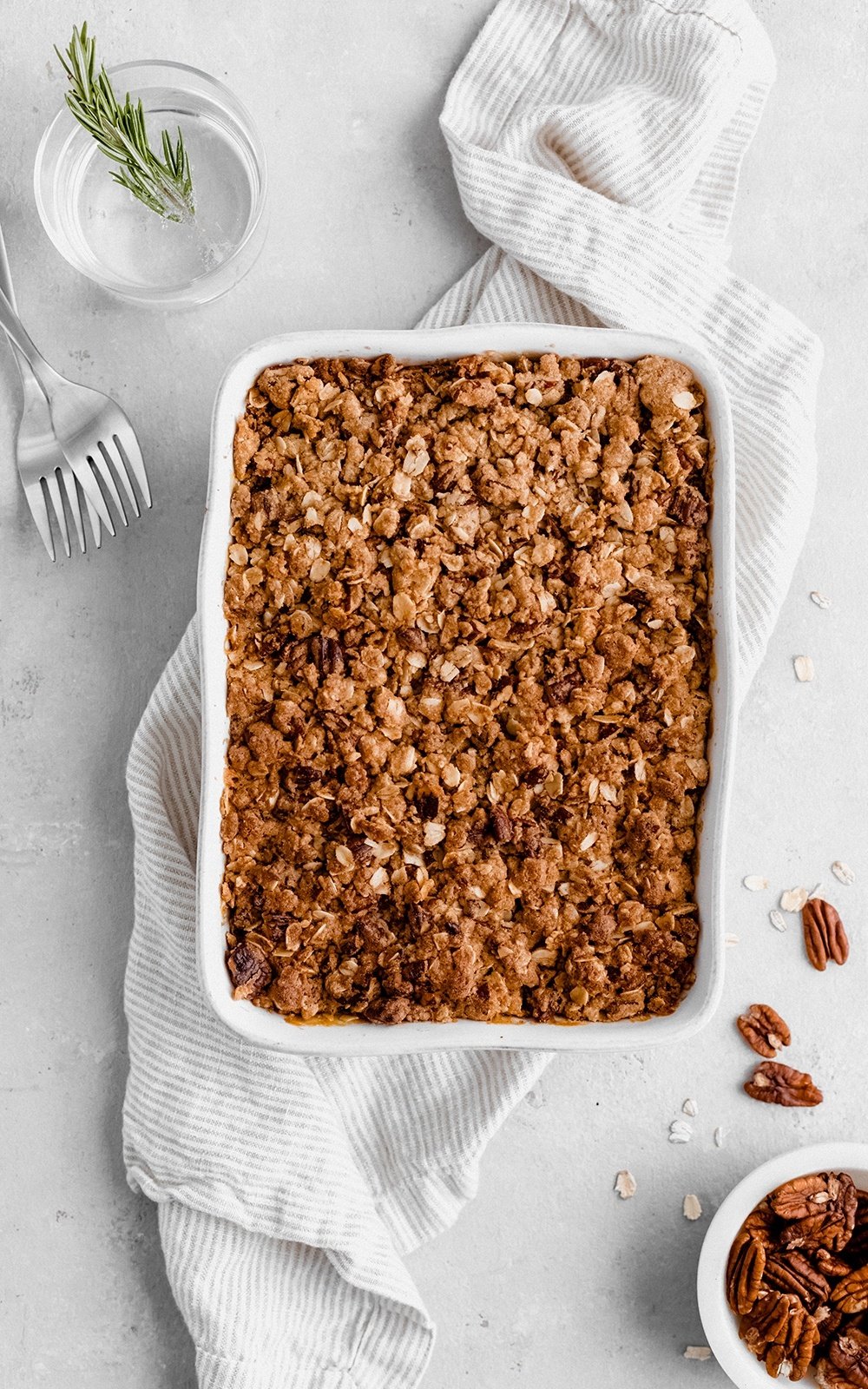 healthy sweet potato casserole in a baking dish on top of a white linen