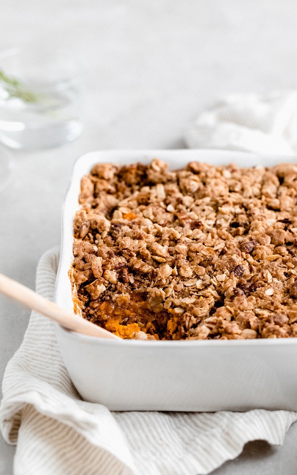 healthy sweet potato casserole with oatmeal topping in a baking dish