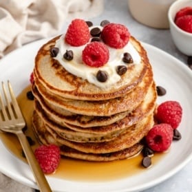 stack of gluten free yogurt pancakes topped with raspberries